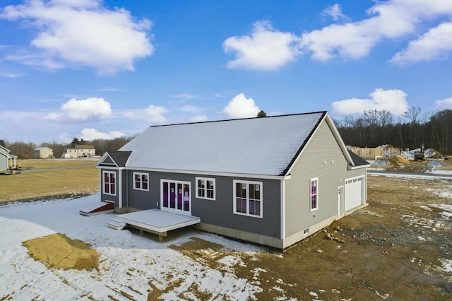 rear view of property featuring a garage