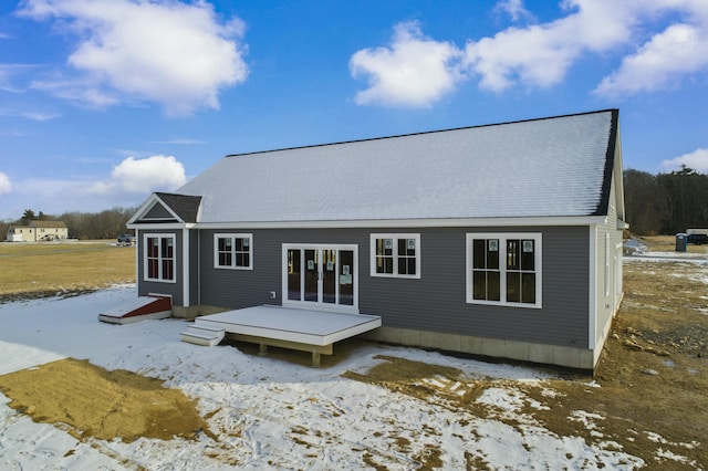 snow covered house with a deck