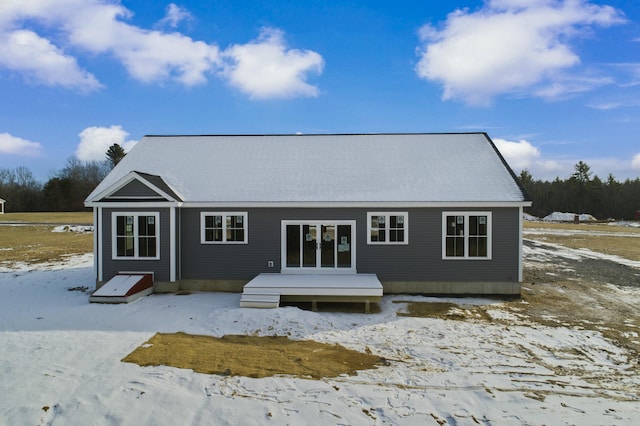 snow covered rear of property featuring a wooden deck