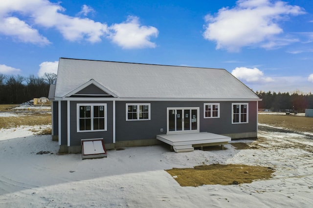 snow covered property with a deck