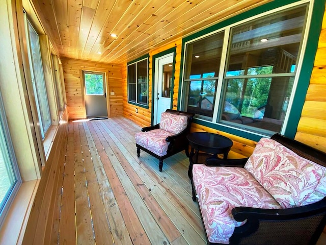 unfurnished sunroom featuring a healthy amount of sunlight and wooden ceiling