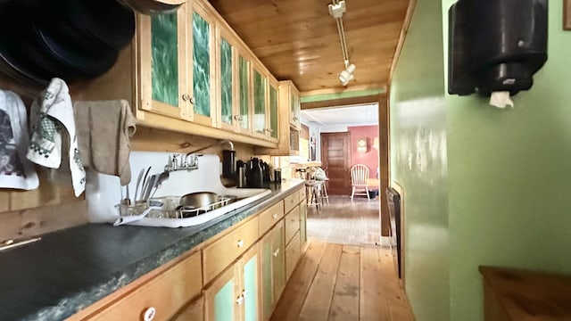 kitchen with light brown cabinets, light wood-type flooring, sink, and wood ceiling