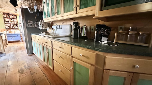 kitchen with light hardwood / wood-style floors and light brown cabinets