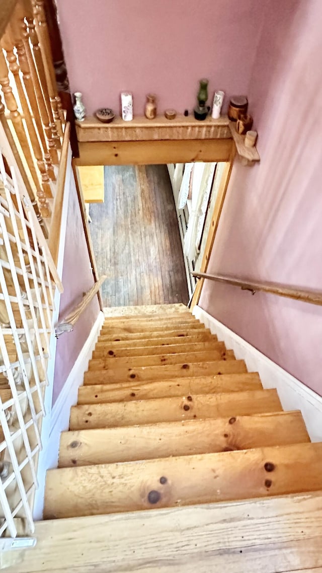 stairs featuring hardwood / wood-style flooring