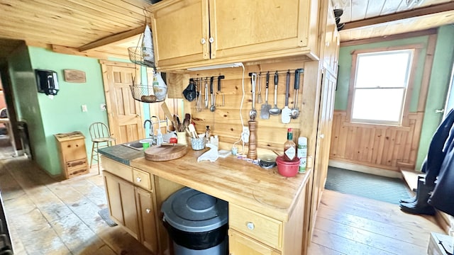 interior space with beam ceiling, butcher block counters, wooden ceiling, and light hardwood / wood-style flooring