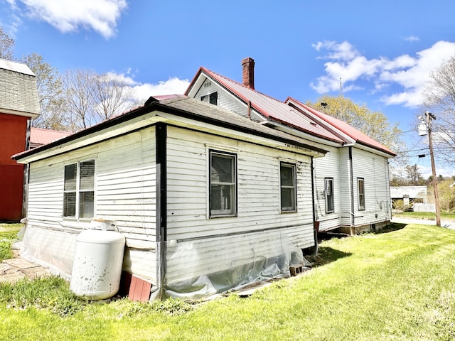 view of property exterior with a yard