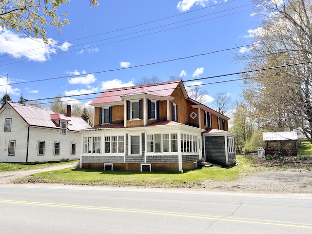 view of front of house with a sunroom