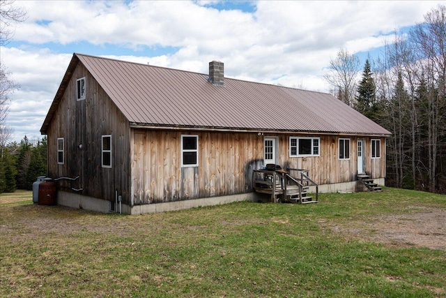 back of property featuring a yard