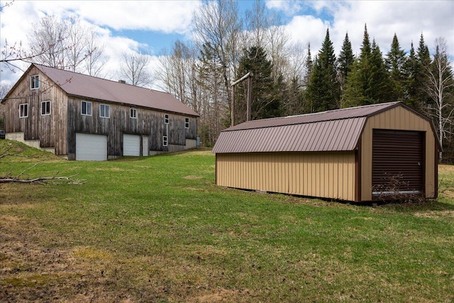 view of yard with a garage and an outdoor structure