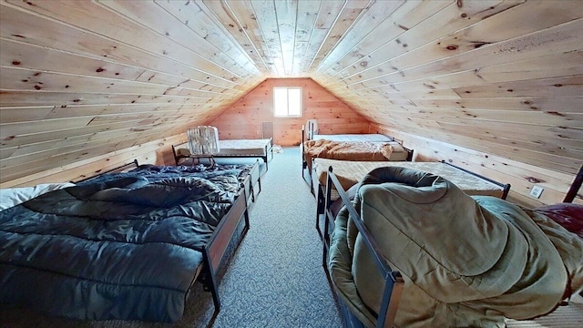 carpeted bedroom with wooden walls, wood ceiling, and vaulted ceiling