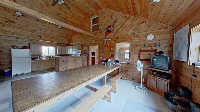 kitchen with white appliances, wood ceiling, and wood walls