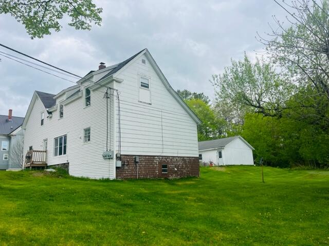 rear view of property with a yard