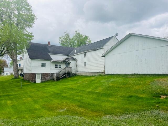 back of property featuring a lawn