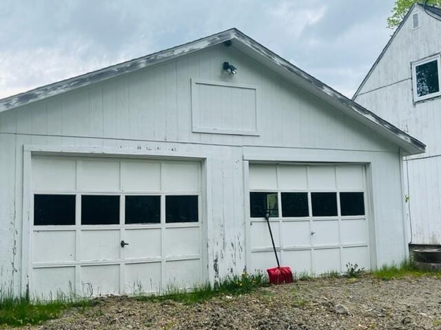 view of side of property with a garage and an outdoor structure