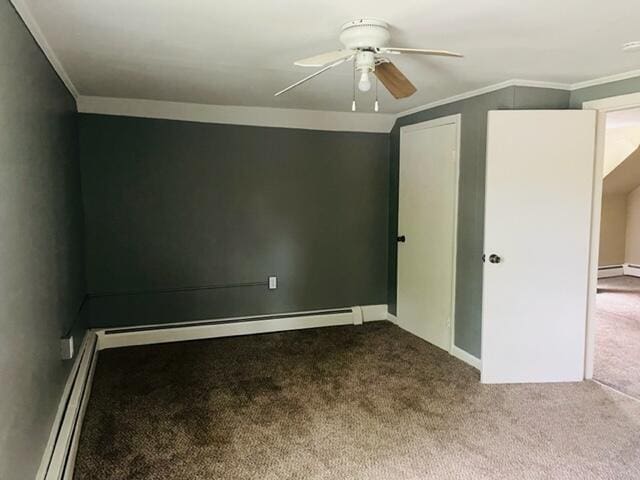 carpeted empty room with ceiling fan, baseboard heating, and ornamental molding