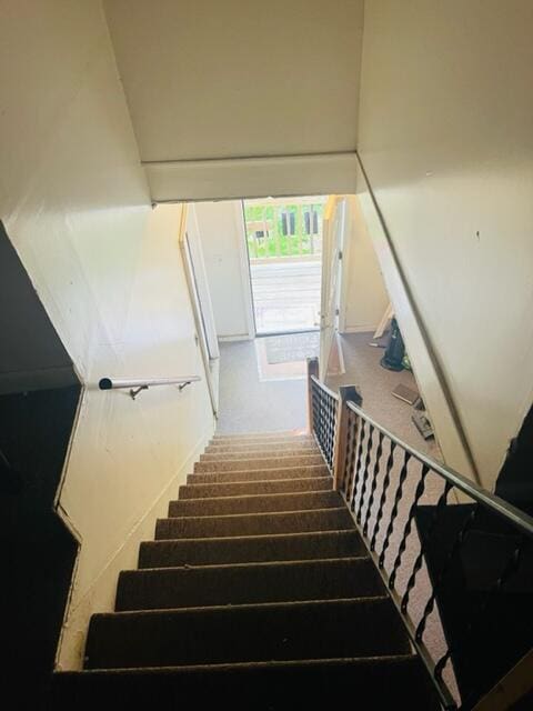 staircase featuring a high ceiling