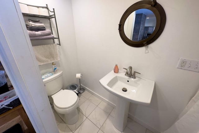 bathroom featuring toilet and tile floors