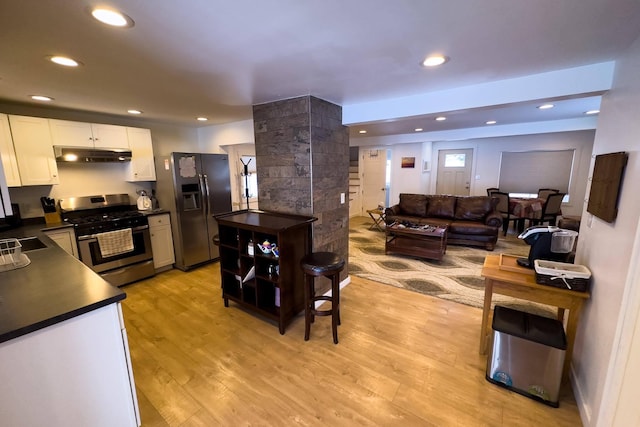 kitchen featuring white cabinets, light hardwood / wood-style flooring, and stainless steel appliances