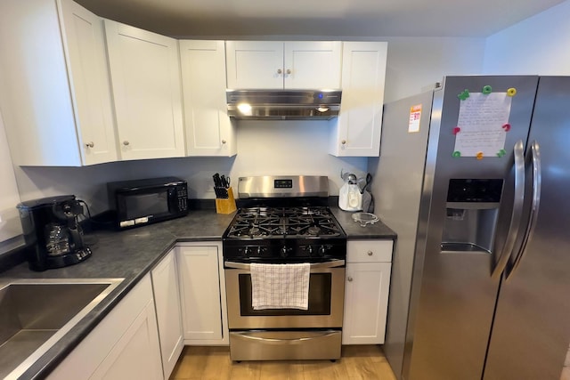 kitchen featuring stainless steel appliances, light hardwood / wood-style flooring, white cabinets, and sink