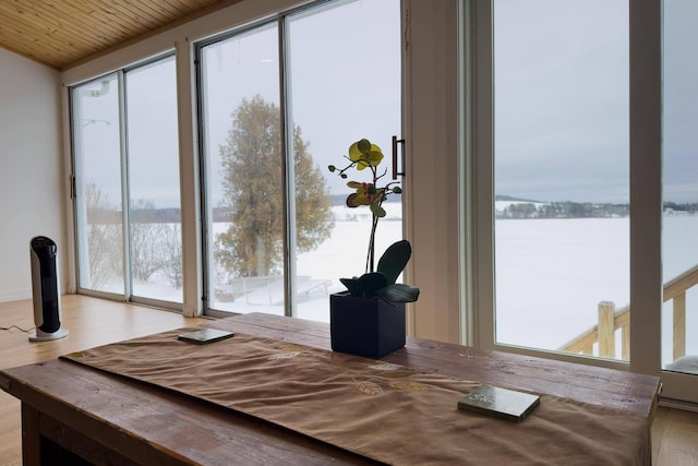 dining room featuring wooden ceiling, a wealth of natural light, and light wood-type flooring