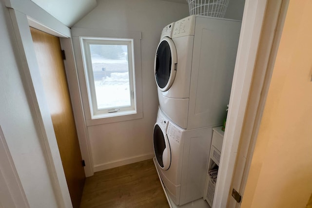 washroom featuring stacked washer / dryer and hardwood / wood-style floors