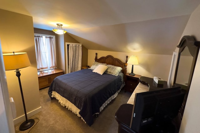 carpeted bedroom with vaulted ceiling