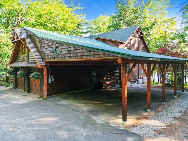 view of car parking with a garage and a carport
