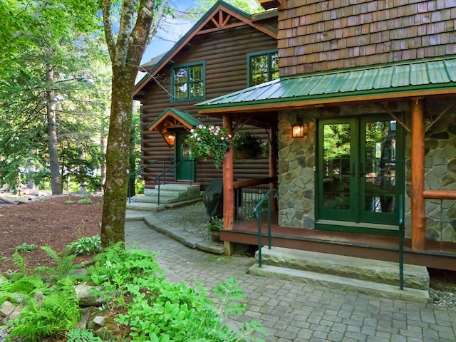 exterior space featuring french doors and log siding