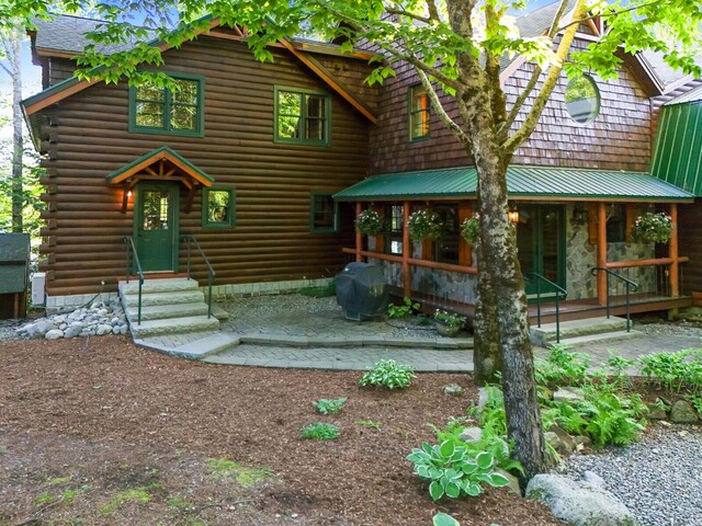 cabin with entry steps and log siding