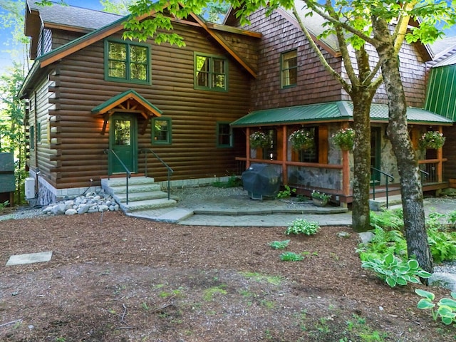 log cabin with entry steps and log exterior