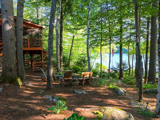 view of yard featuring a deck with water view