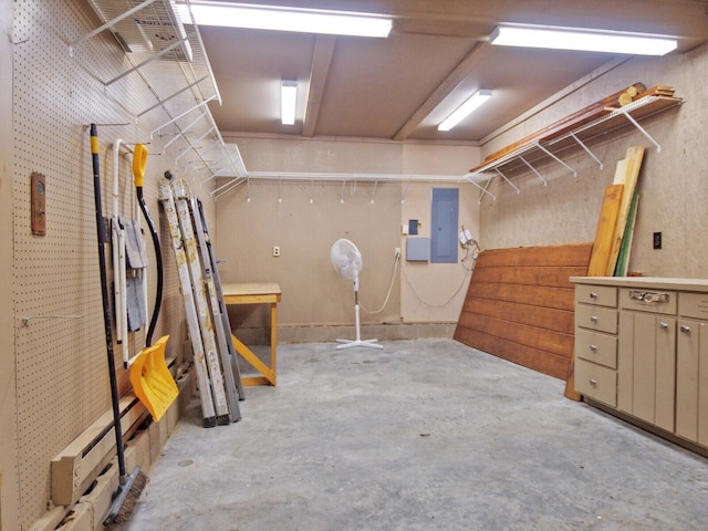 basement with electric panel and a workshop area