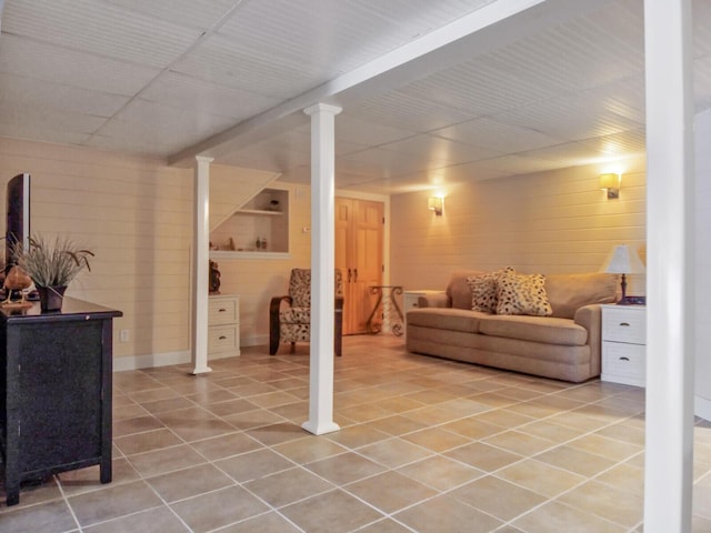 finished basement with light tile patterned flooring
