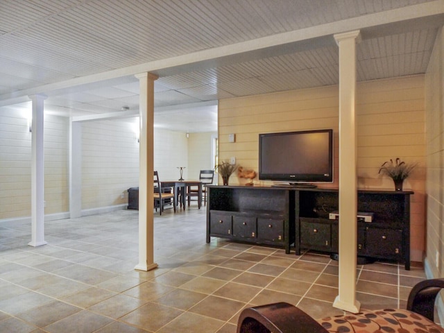 living area featuring decorative columns and tile patterned floors