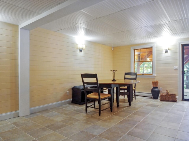 dining room with baseboards, a baseboard radiator, and tile patterned floors