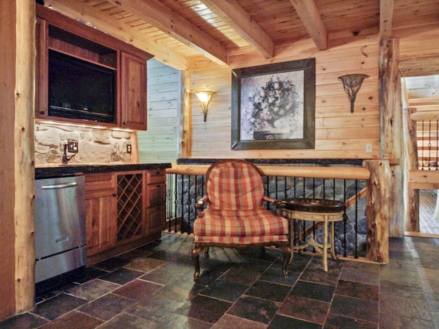 sitting room featuring wooden ceiling, wooden walls, stone finish floor, and beam ceiling