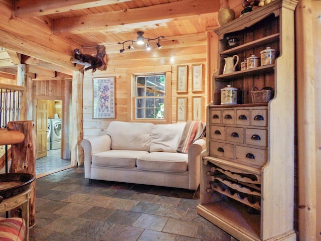 sitting room featuring wooden ceiling, stone finish flooring, beamed ceiling, and wood walls
