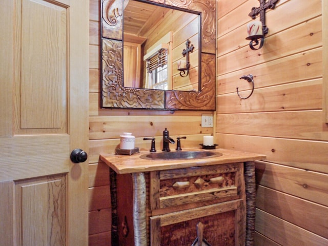 bathroom featuring wood ceiling, wood walls, and vanity