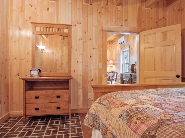 bedroom featuring an AC wall unit, wood walls, brick floor, and baseboards