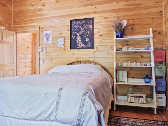 bedroom featuring wooden walls