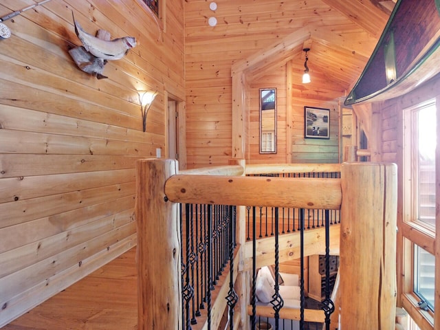 stairway featuring wood walls and vaulted ceiling