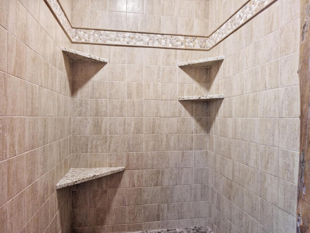 bathroom with tiled shower