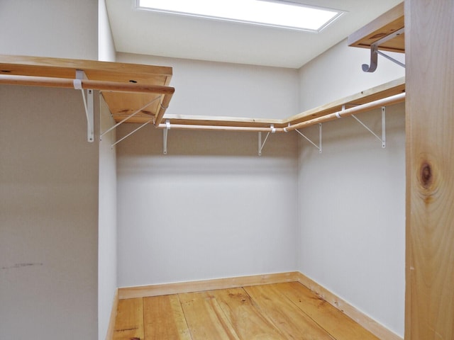 spacious closet with hardwood / wood-style floors