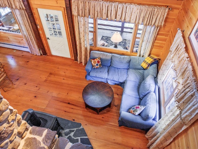living room featuring a baseboard heating unit and hardwood / wood-style floors