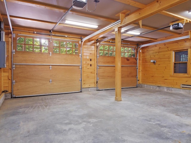 garage featuring wood walls, electric panel, and a garage door opener