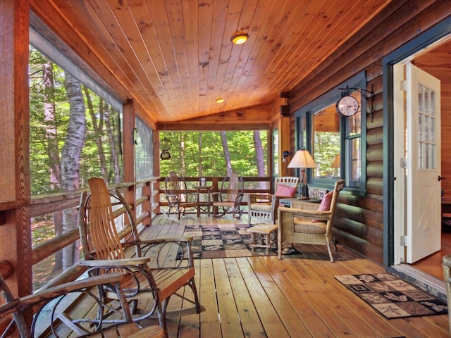sunroom featuring lofted ceiling and wooden ceiling