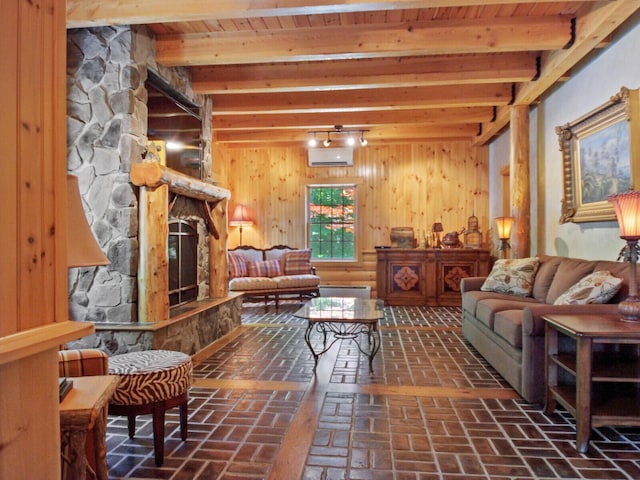 interior space featuring brick floor, an AC wall unit, a fireplace, and beam ceiling