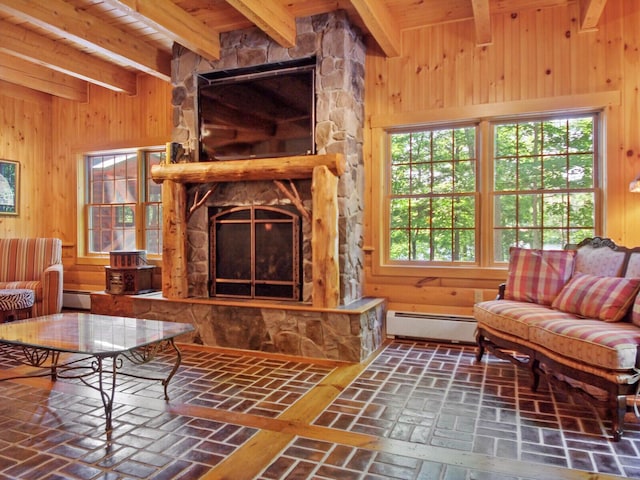 living room with brick floor, wooden walls, a baseboard heating unit, a fireplace, and beamed ceiling