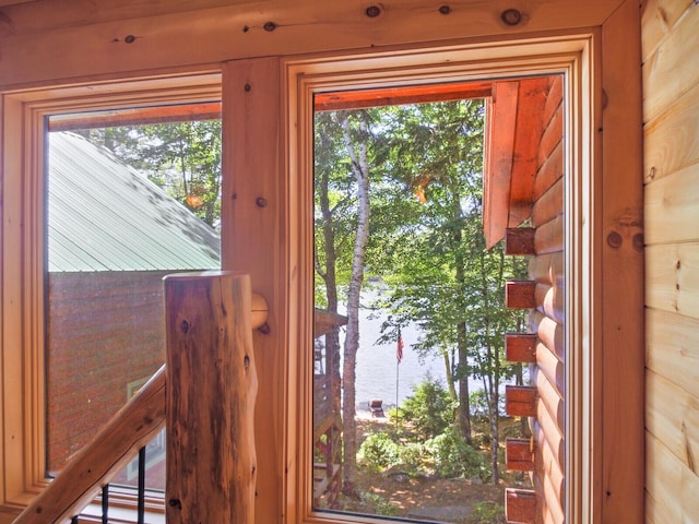 doorway with a water view and plenty of natural light