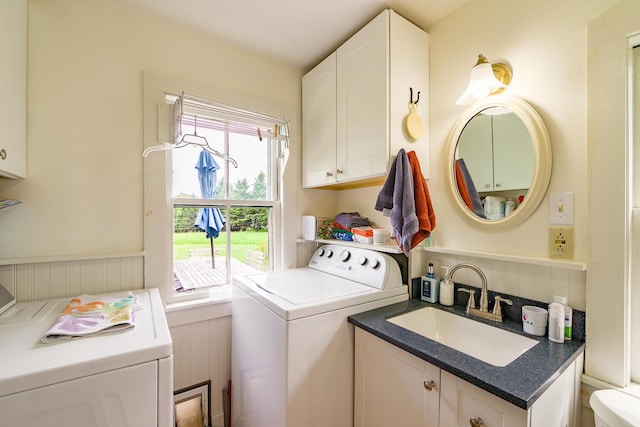 clothes washing area featuring separate washer and dryer and sink